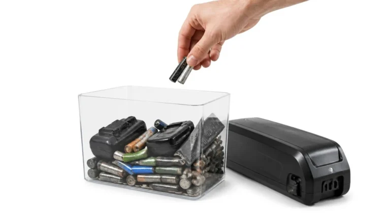 Spent batteries dropped into a collection box, next to an e-bike battery