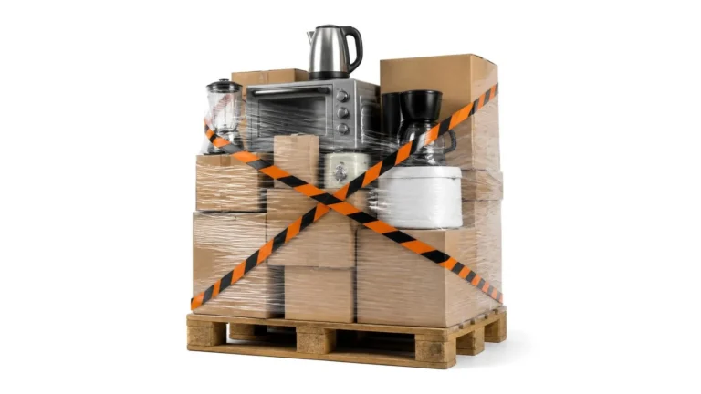 Pallet of small household appliances wrapped in film and crossed out with orange and black striped tape: goods under seizure.